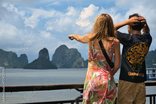 Couple exploring Ha Long Bay Vietnam landscape