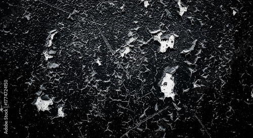 Intense abstract texture showcasing distressed black paint peeling to reveal a gritty white undercoat, perfect for grunge or industrial backdrops.
