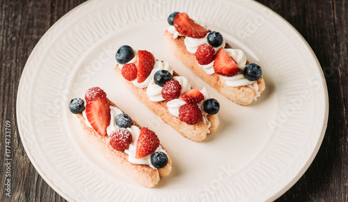 Tiramisu-style dessert with savoiardi, cream cheese and berries. Sweets and desserts.