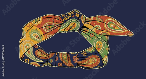 A close-up view of a paisley patterned headband with a knotted design, showcasing vibrant colors and intricate details.