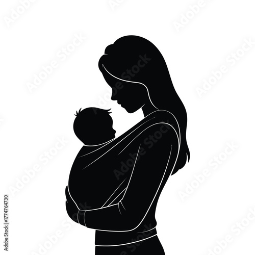 Silhouette of mother holding baby in a sling