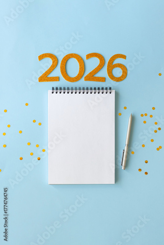New Year 2026 planning concept with notebook and golden numbers for your goals, plans, resolutions. Flat lay style. Christmas planning concept with space for text