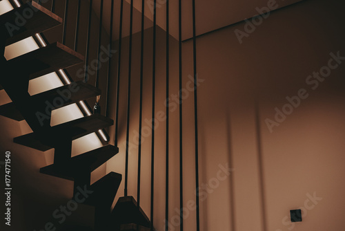 Modern staircase with wooden steps and metal railings in a contemporary home. The architectural design of the staircase creates a visually appealing and functional element within the interior space.