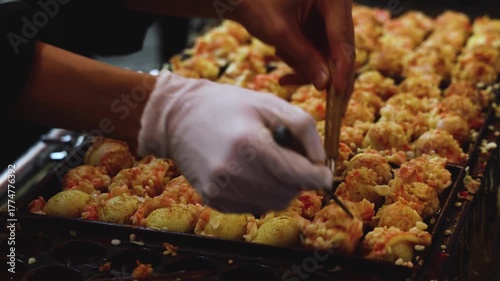 Takoyaki - popular Japanese Street Food, deep-fried dough octopus dumpling balls, variety of different traditional food snack selection in Osaka, Japan, street market with local vendor stalls cooking