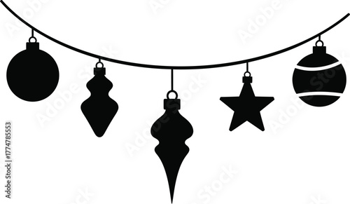 Silhouette of assorted christmas ornaments hanging on a string