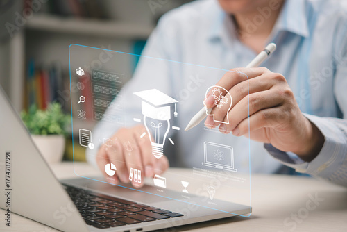 Businessman brainstorming creative ideas on futuristic education interface. Using technology online learning, skill development, and personal growth. E-learning knowledge innovation concept on laptop.