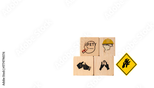 Safety icons on wooden blocks with gloves warning sign against a solid black background