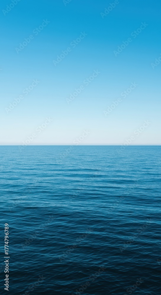 Obraz premium A wide angle view of deep blue water stretching to the distant horizon under a bright sky, emphasizing tranquility and vastness ,immense ,deep water ,nautical