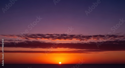 Beautiful sunset over the sea with clouds and orange sky tranquil scene of nature with sun setting on the horizon calm and peaceful seascape at dusk with colorful sky