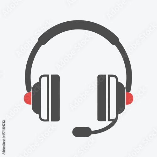 Grey headset with red earphone accents and microphone is placed on plain background