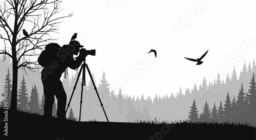 Silhouette of a wildlife photographer with a camera on a tripod.