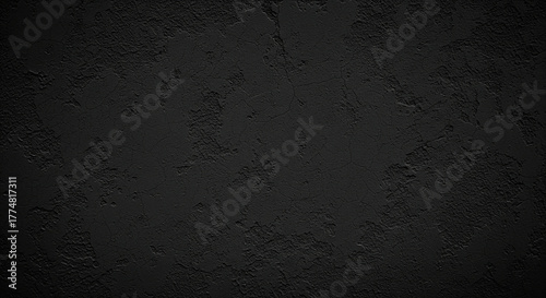 A textured wall background with a rough and coarse plaster finish, entirely black in color. A dark and dramatic atmosphere.