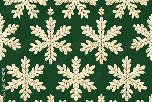 Seamless knitted snowflake pattern on green fabric