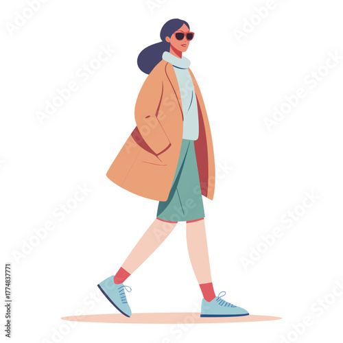 Stylish woman in sunglasses and a trench coat walking confidently on a white background