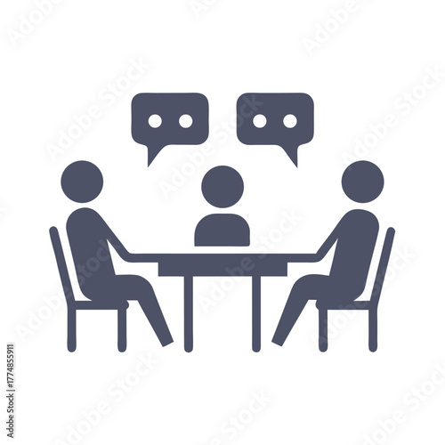 Three people are sitting around a table talking to each other attentively