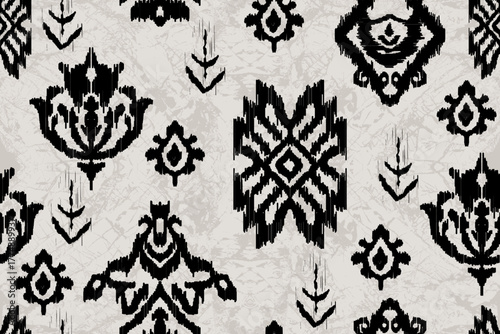 Black and gray Ikat pattern featuring traditional ethnic motifs and a textured background. perfect for fabric prints, wallpaper, wrapping paper, fashion textiles, and digital backgrounds