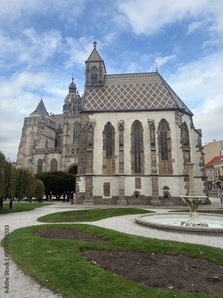 Fototapeta premium St Michael Chapel in Košice Slovakia main square with its characteristic patterned roof and St Elisabeth Cathedral behind it