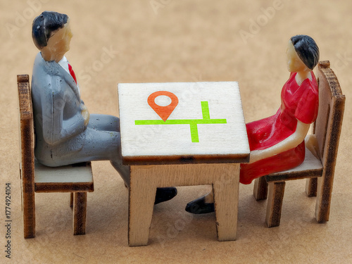 Business meeting with miniature figures discussing plans over a table