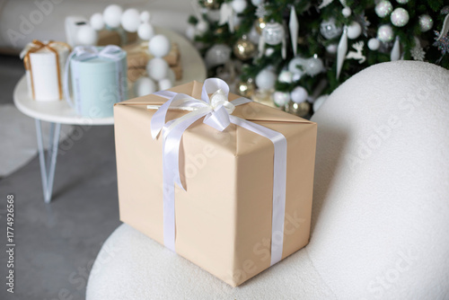 Gift box with white ribbon on Christmas background