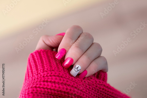 Beautiful female hand with pink manicure nails, crown design