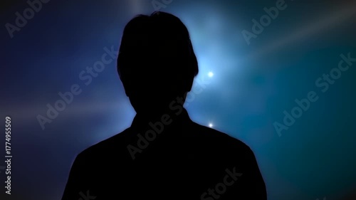Medium shot man in silhouette taking to camera