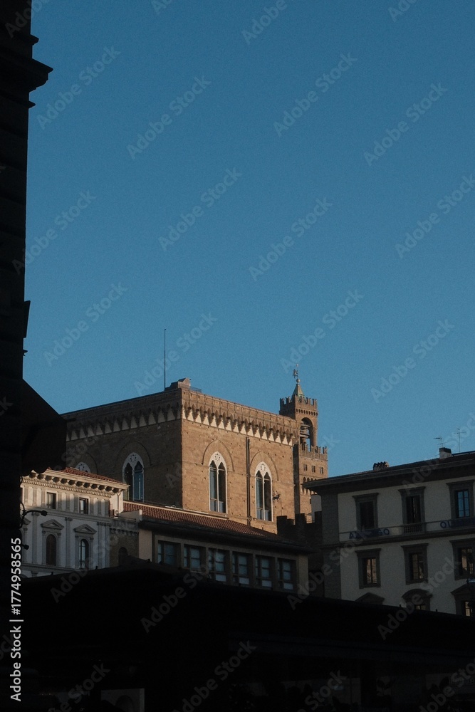 Obraz premium Florence building facade bathed in golden hour light with blue sky with analog film effect