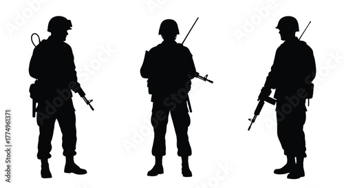 Three soldiers standing in silhouette with rifles facing forward