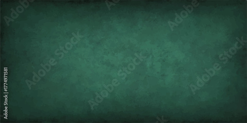 Dark, vintage green chalkboard wall with a textured, rough grunge surface for a blank backdrop