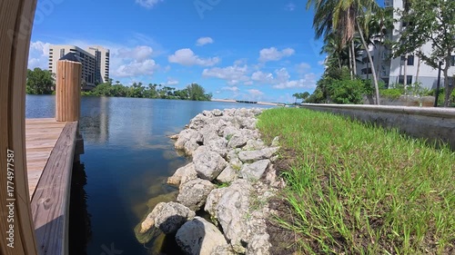 Small wooden pier overlooking a river through rocky shoreline