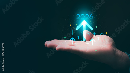 Businessman with an arrow rising to 2026 symbolizing future growth, business goals, strategic vision, and organizational development direction