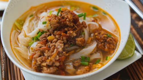 Tableau sur toile Traditional Lao Khao Soi noodle soup with minced pork ragu sauce in a bowl