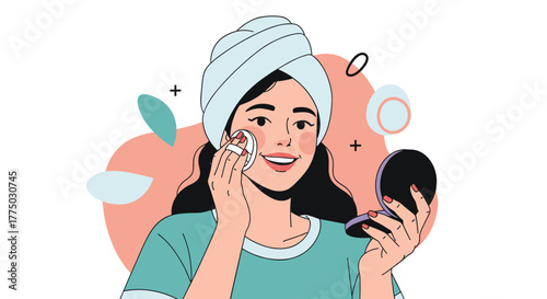 A happy woman with a towel on her head applies face powder with a puff while looking into a compact mirror, completing her beauty routine.