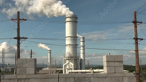 Industrial Chimney Emitting a Plume of White Vapor Against a Clear