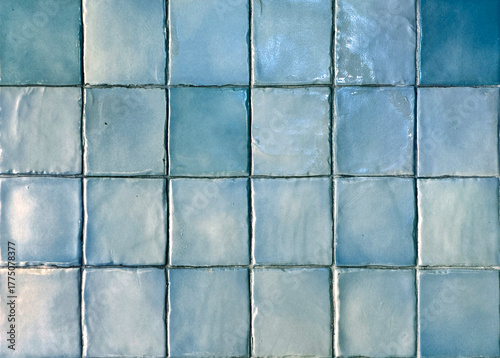 Close up of blue tiles, or blue porcelain mosaic tiles. Suitable for pool flooring or wall decoration, bathroom and kitchen tiles. Seamless background texture.