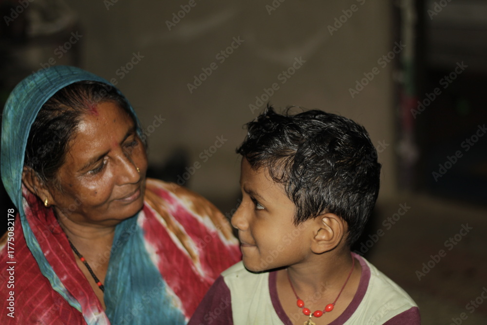 Naklejka premium Emotional portrait of an elderly woman with her grandchildren, symbolizing unconditional love, happiness, and the strength of family relationships in Indian culture.