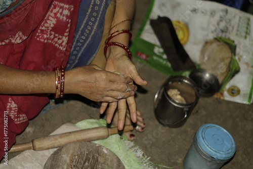 Traditional Indian cooking scene showing a woman shaping chapati dough, representing love, care, and the everyday rhythm of rural and urban Indian life.