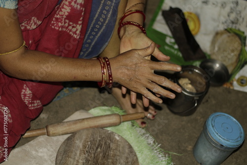 Traditional Indian cooking scene showing a woman shaping chapati dough, representing love, care, and the everyday rhythm of rural and urban Indian life.
