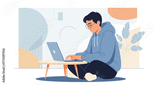 Young Man Working On Laptop At Home In Comfort And Concentrated On His Task