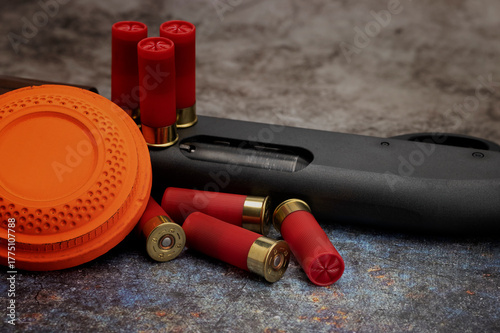Bild auf Leinwand Clay disc flying targets and shotgun shells on texture background ,Clay Pigeon t