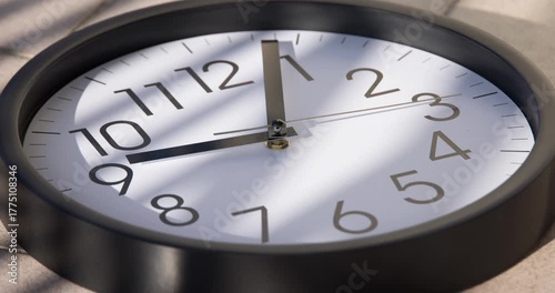 Sun and sky reflecting in the watch during the time passing by. Time lapse on a modern white Clock on black. Close up to a wall clock, with running time pointer. Wall clock show the running time