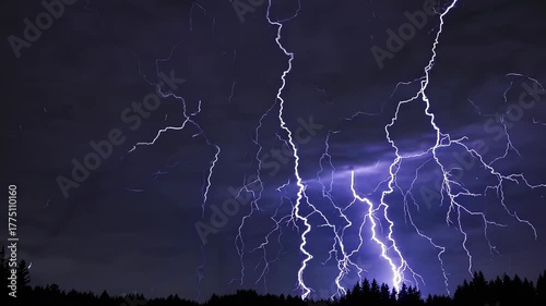 Striking blue bolts of lightning brighten the darkened sky at night