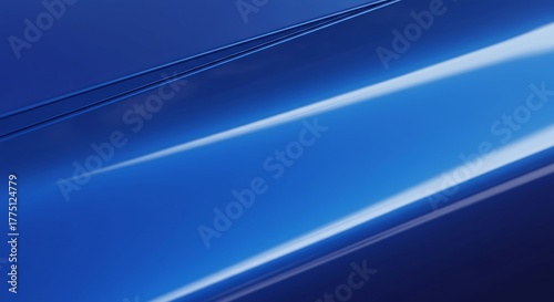 Abstract view of a glossy blue car hood with two narrow lines and a large area of light reflecting diagonally across it