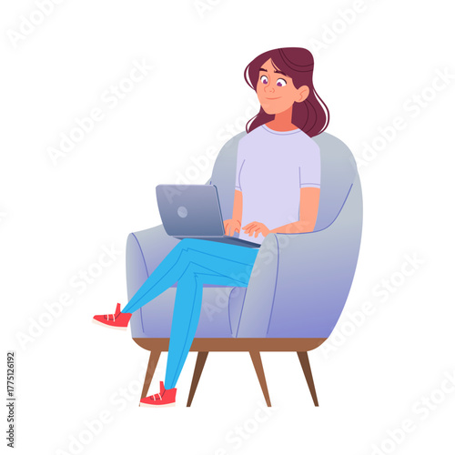 Smiling young woman sits comfortably in an armchair, using her laptop.
