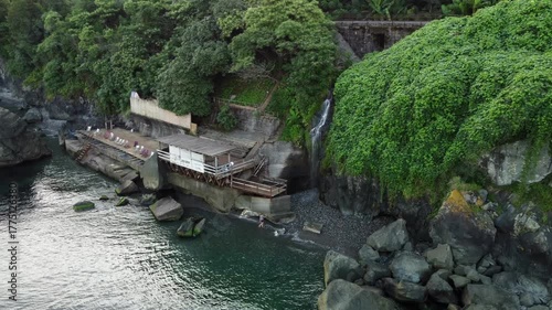 Peaceful haven surrounded by vibrant greenery and rushing streams, Tranquil mountain overlooking verdant forests with cascading waterfalls and peaceful natural beauty