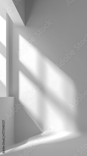 Clean white room corner showcasing shadows cast by window light, modern architectural design