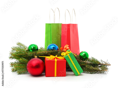 Gifts with fir tree branches and Christmas tree decorations isolated on white.