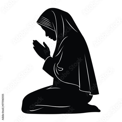 Silhouette of a muslim woman in hijab praying on her knees