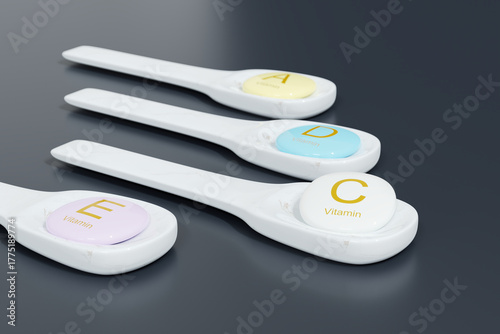 3D render of white spoons holding vitamin tablets A, D, C, and E on a dark surface, symbolizing nutrition, health, and dietary supplements.
