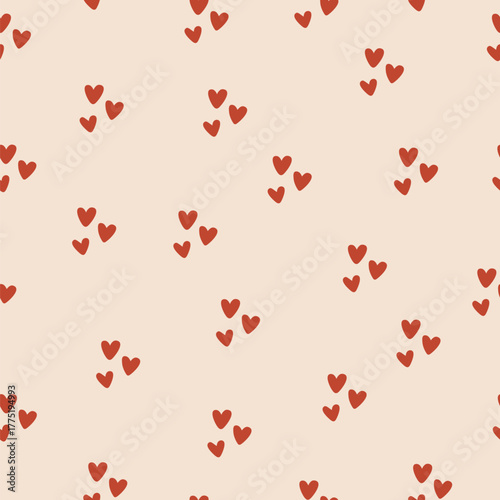Seamless pattern with small red hearts on beige background. Cute romantic vector design for Valentine’s Day, wrapping paper, textile, wedding decor, or love-themed projects.