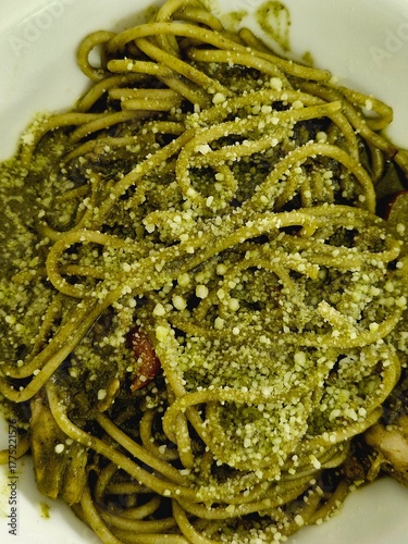closeup of spaghetti pesto on white bowl
